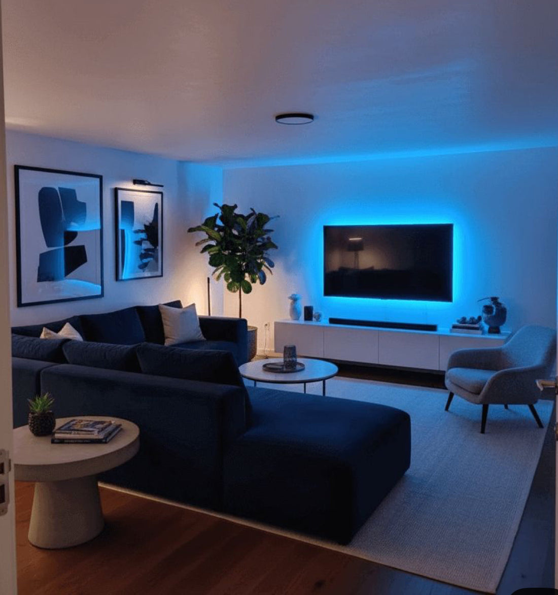 Modern living room with neutral furniture, cozy sofa seating, coffee table, area rug, and home decor accents in a bright apartment space